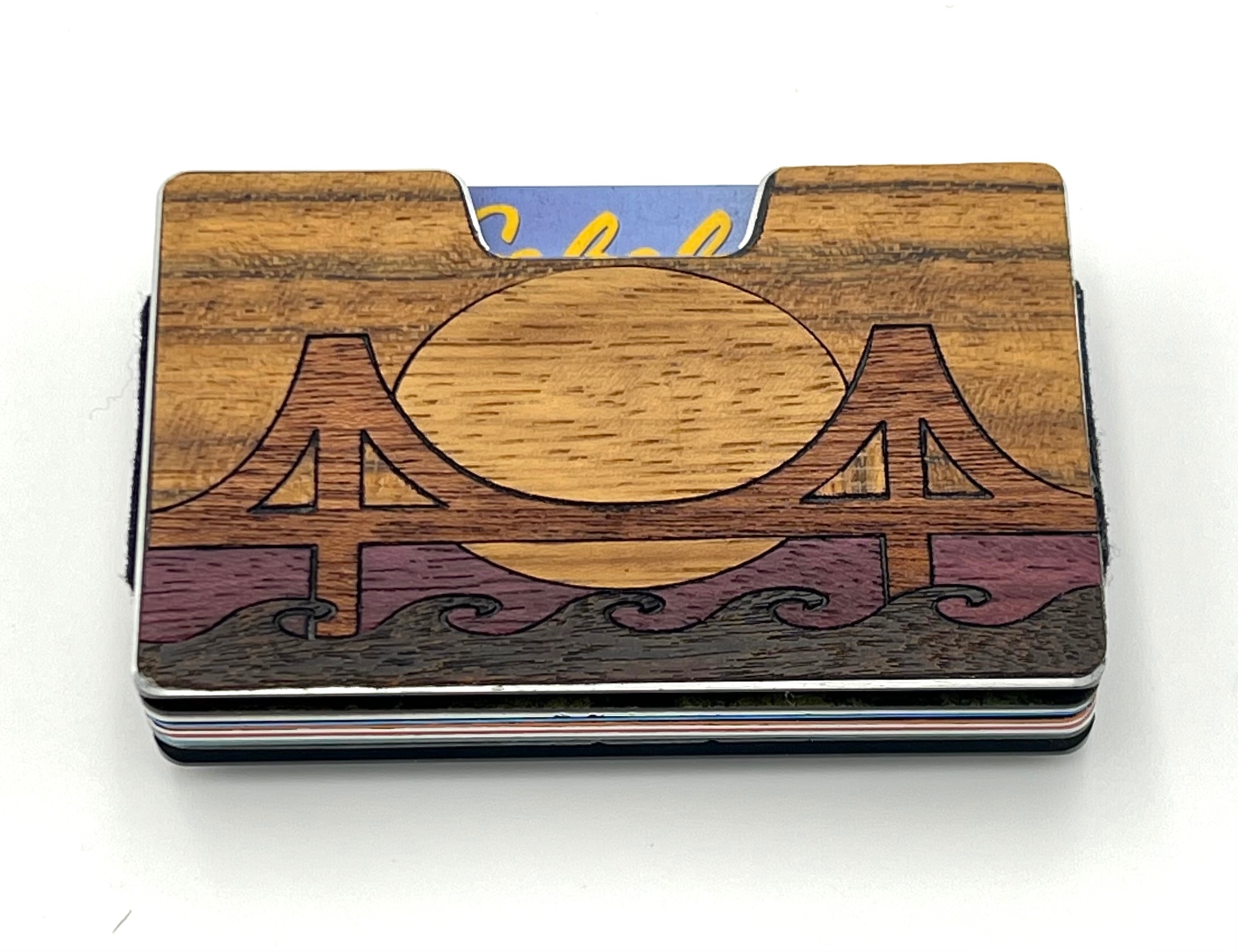 Wood inlay suspension bridge over waves and a setting sun