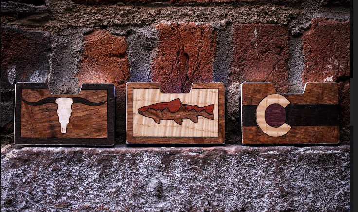 Longhorn, trout and Colorado wood inlay wallets on brick
