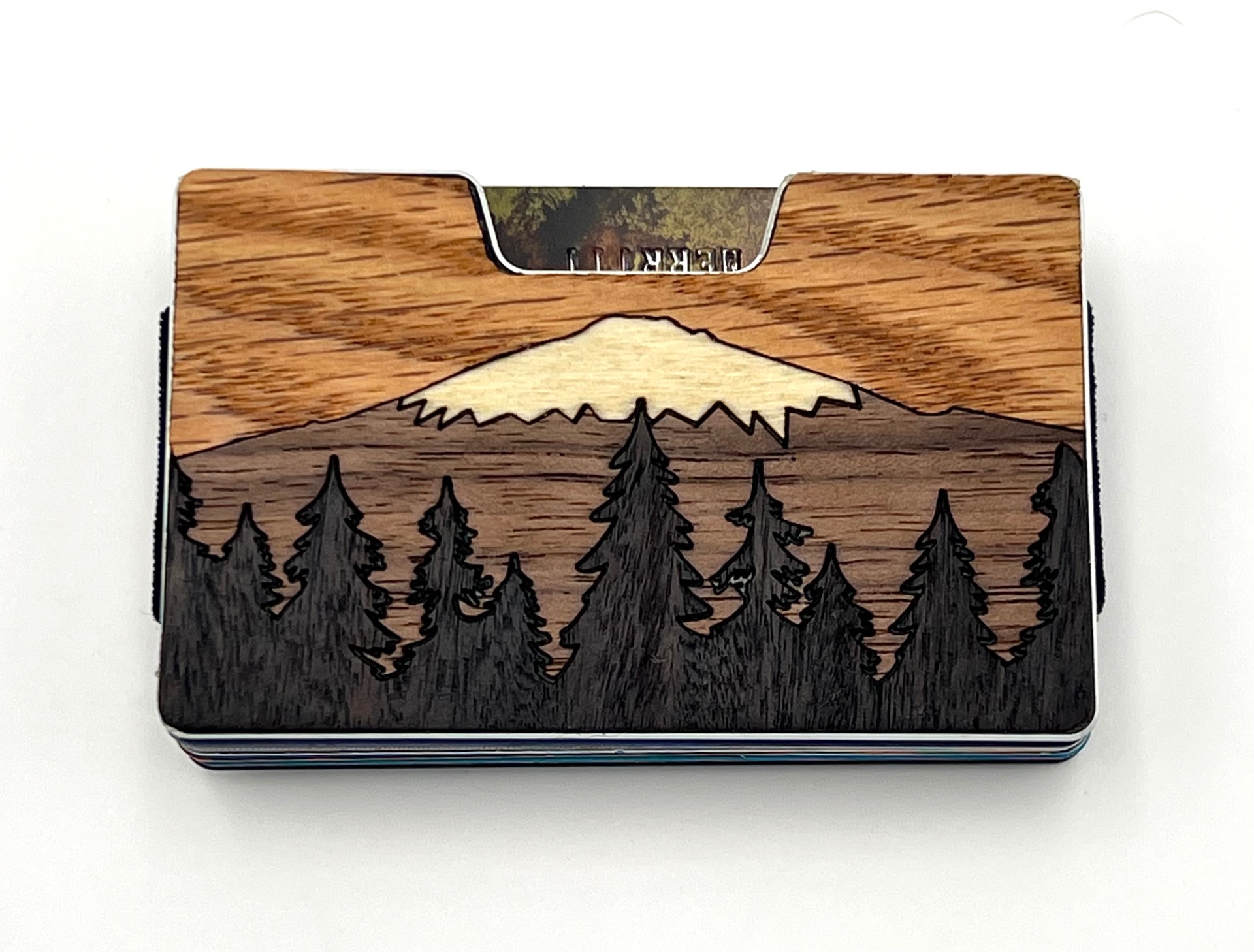 Wood inlay wallet with a snow-capped mountain and pine tree forest scene